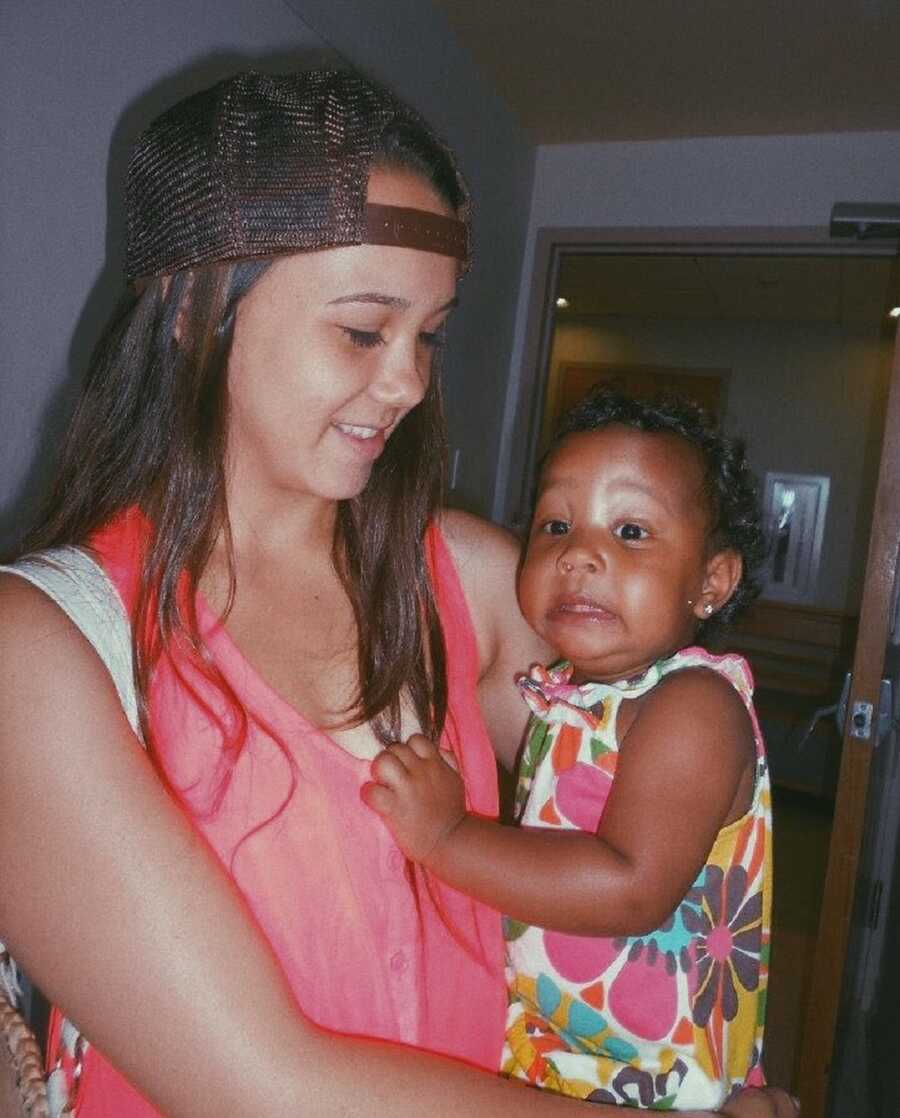teen mom holds baby making funny face