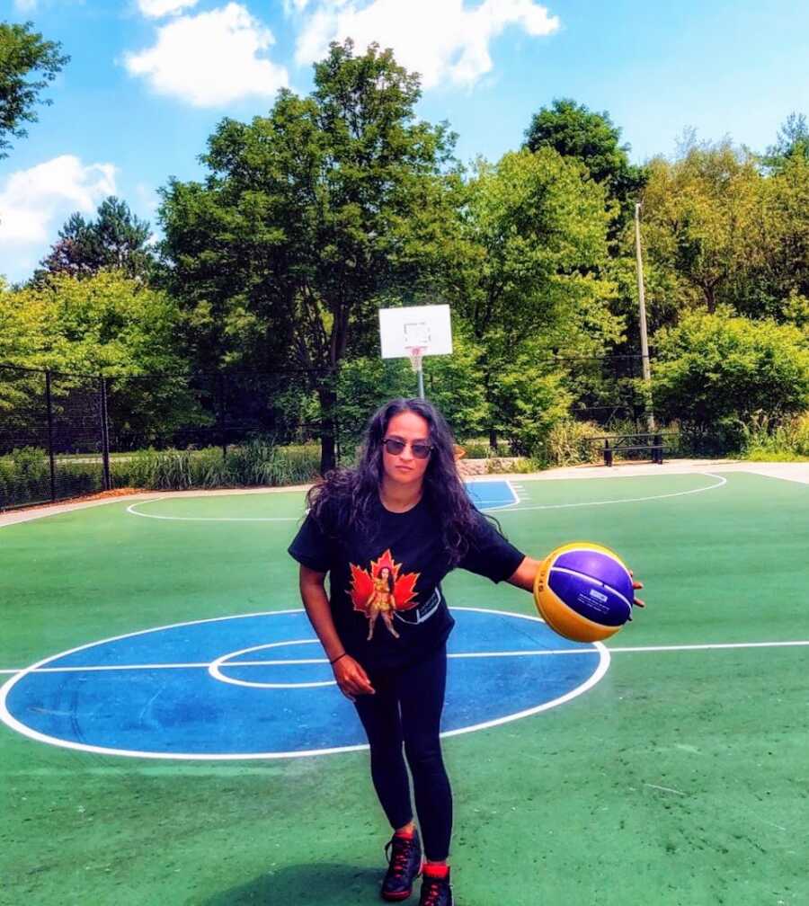 A woman with a rare condition dribbles a basketball 