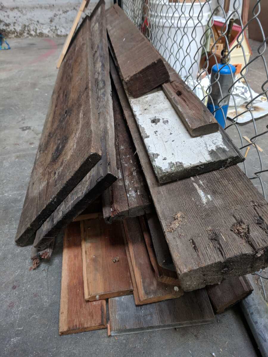 pile of wood planks that are labeled as waste from previous construction projects