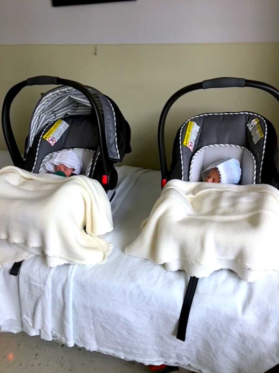 twin baby boys in their car seats about to go home after being in the NICU