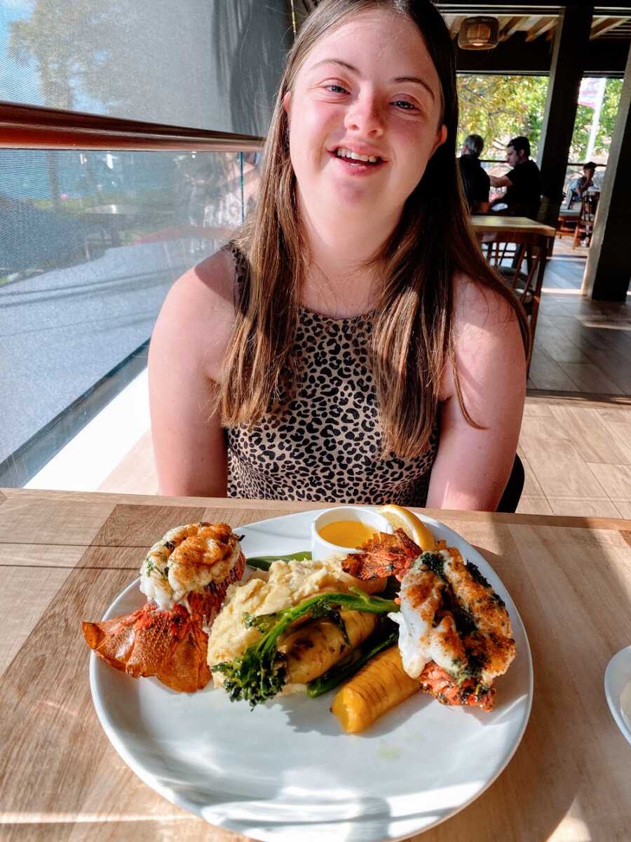 A girl with down syndrome at a fancy restaurant