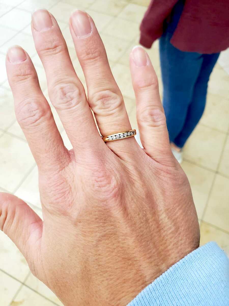 close up of a woman's hand held in front of her while wearing a family heirloom ring