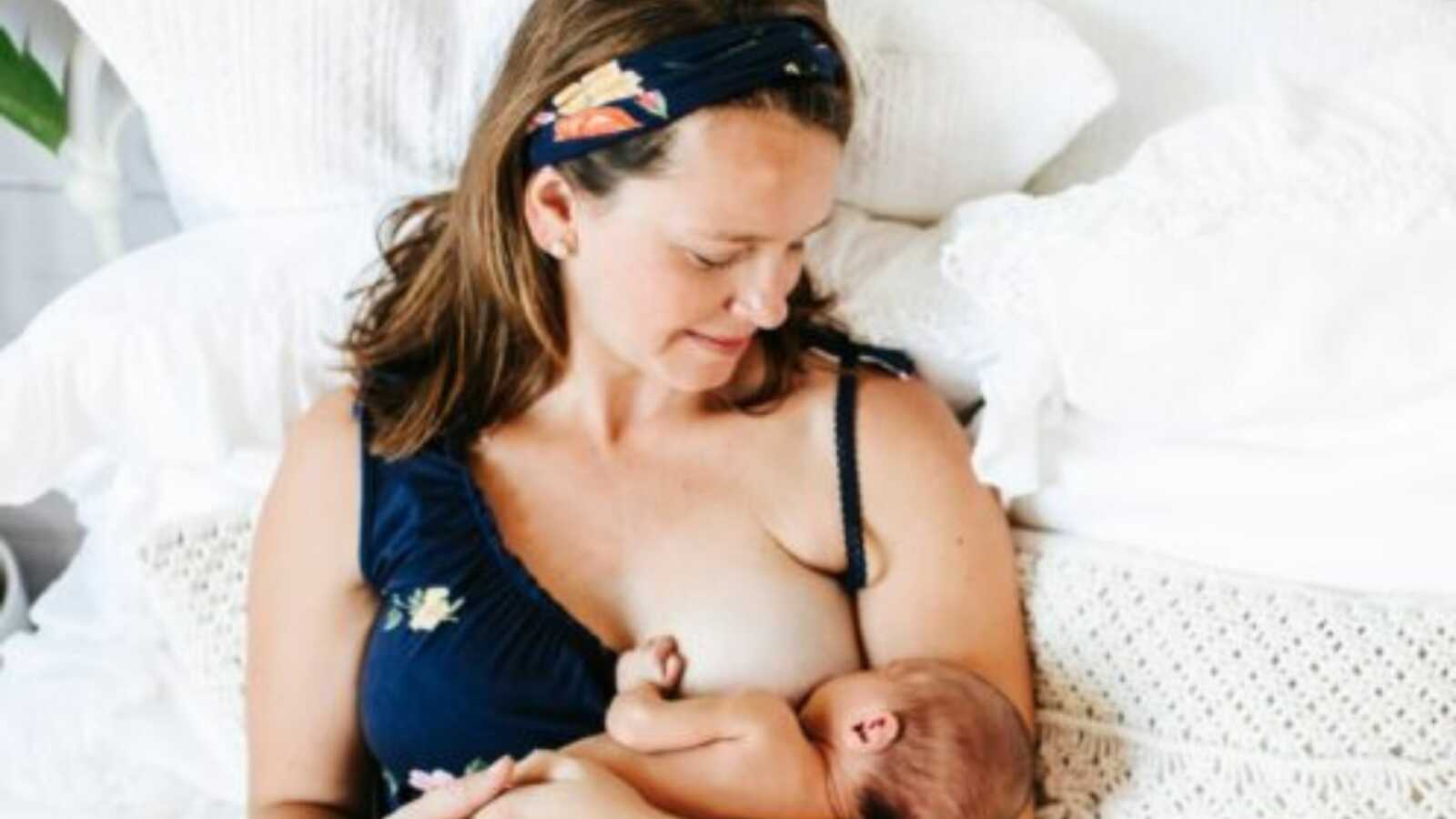 mom with her baby on her chest and breastfeeding the child