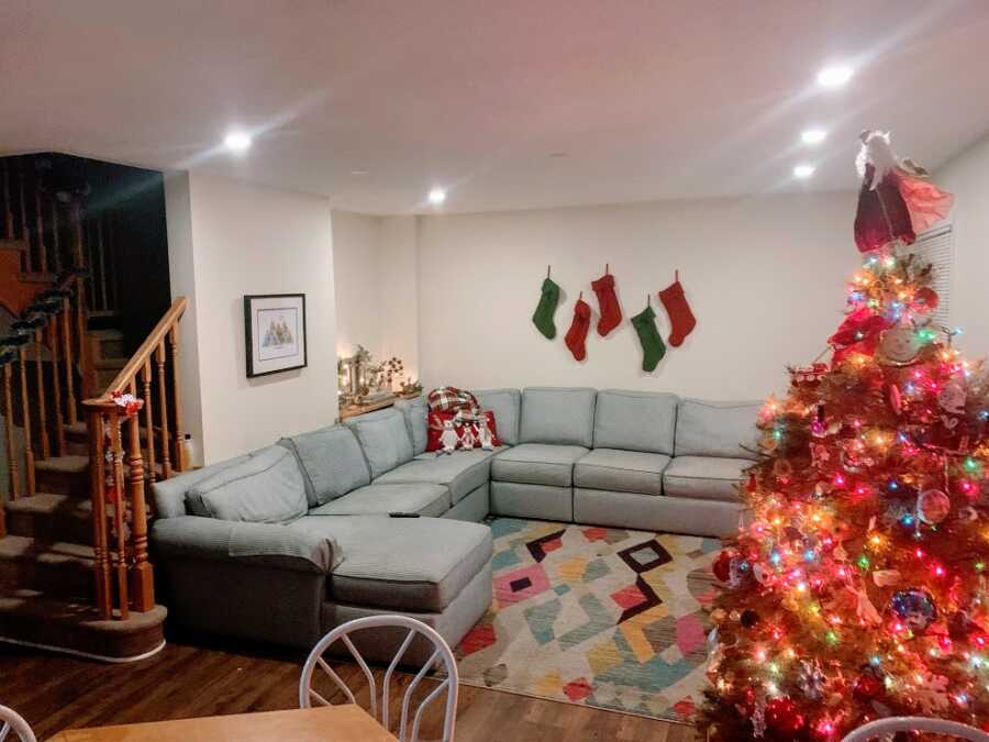 An empty living room with Christmas decorations.