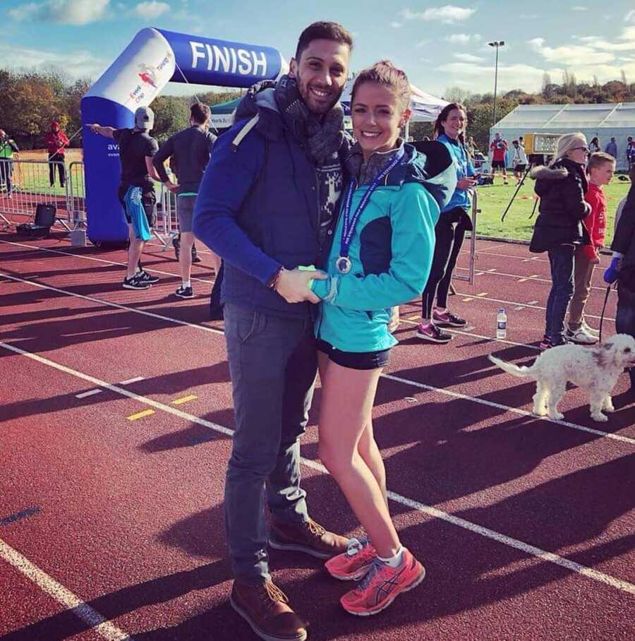 Meg and her partner take a picture as she trains for half marathon. 