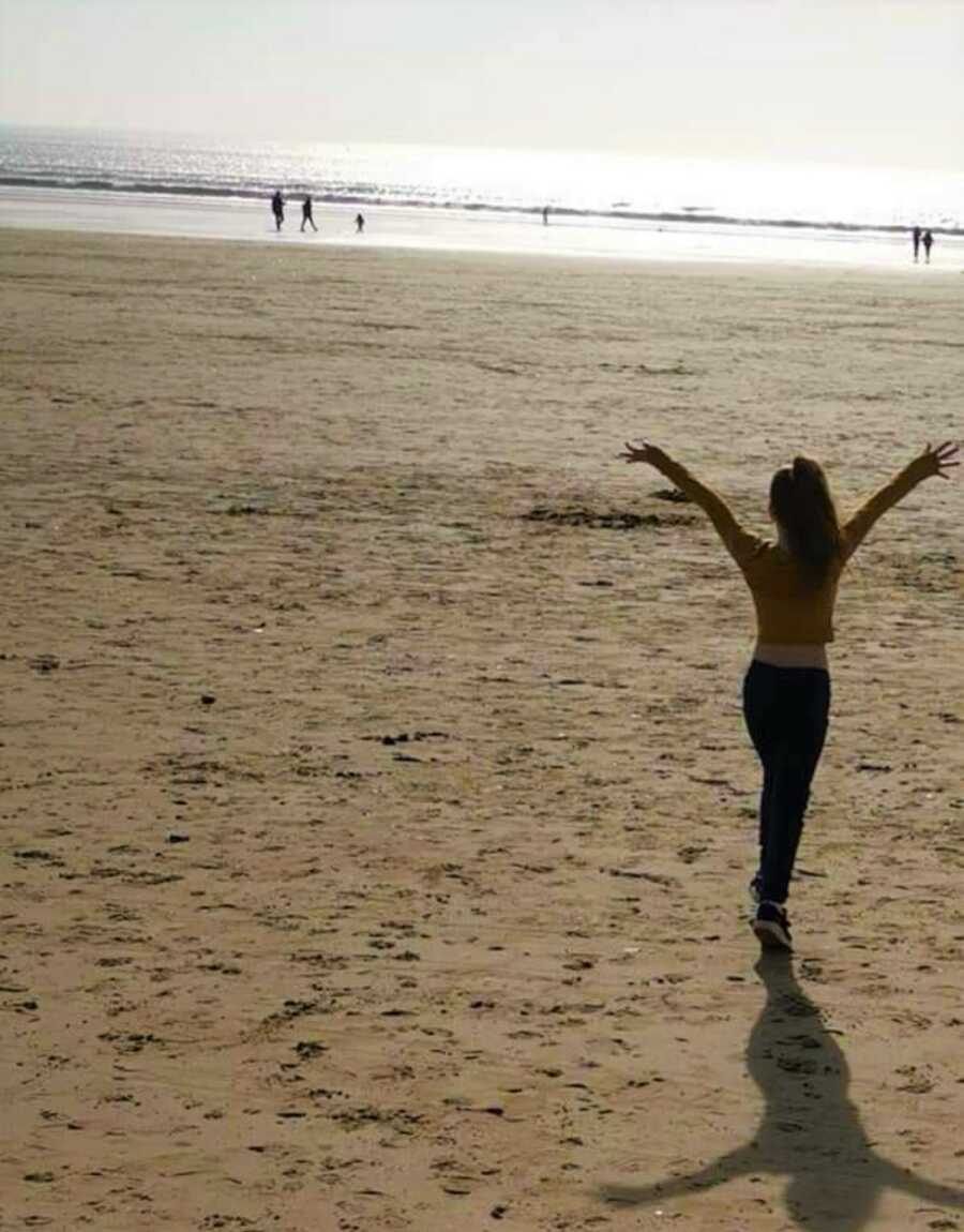 teen daughter who struggles with anxiety enjoys herself at the beach