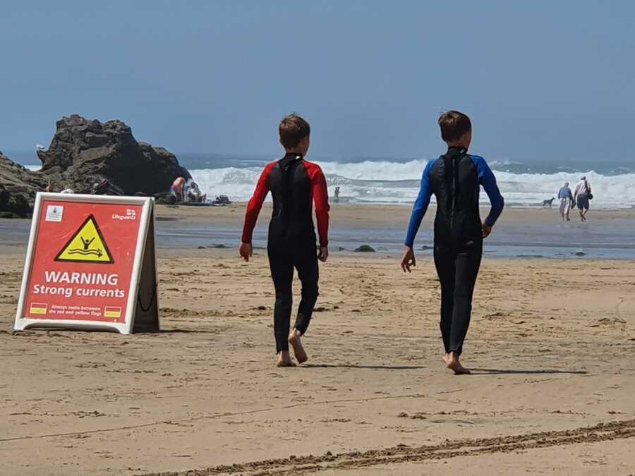 boys going to swim on the beach