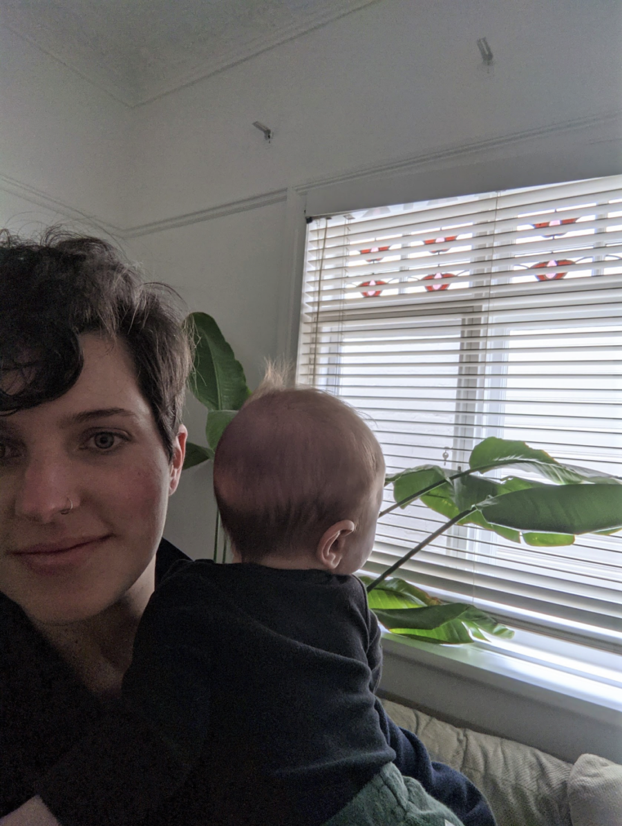 mom holding her baby close and smiling 