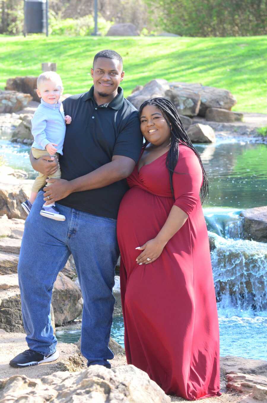 Dad and son pose with mom for maternity photoshoot.
