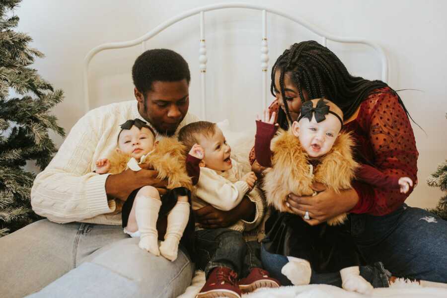 Family poses for adorable winter family pictures.