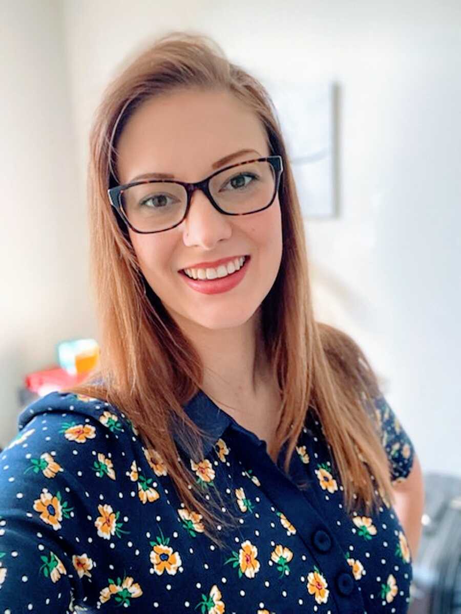 A hopeful mom wearing a blue shirt and glasses