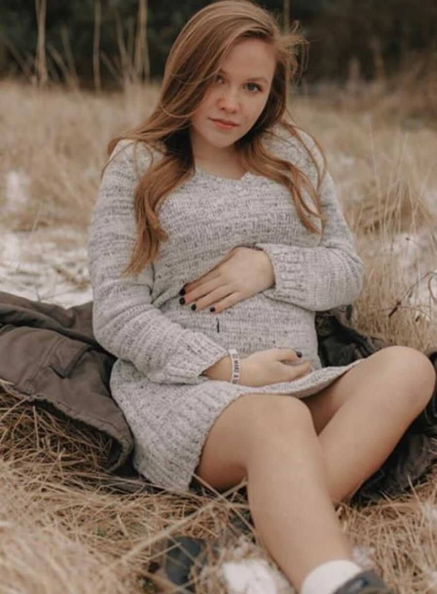 teen mom posing with her pregnant belly