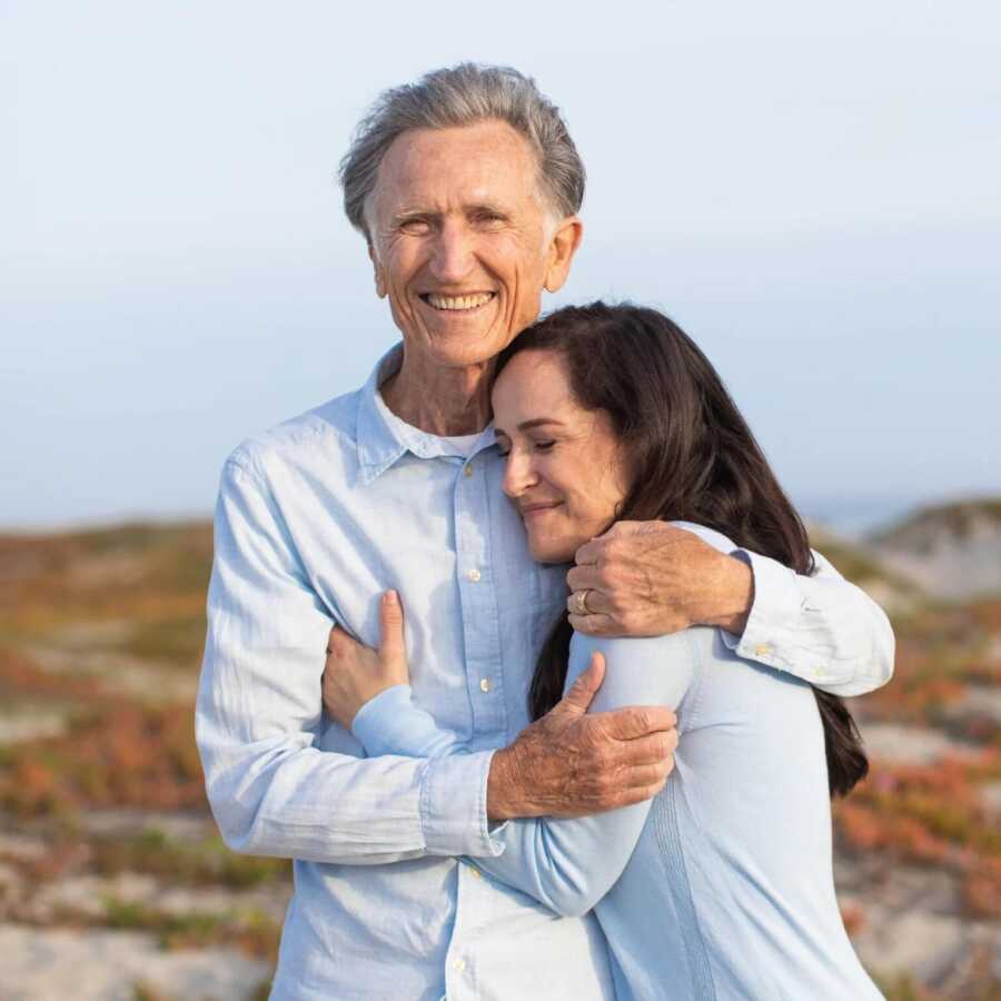 dad and daughter holding each other close