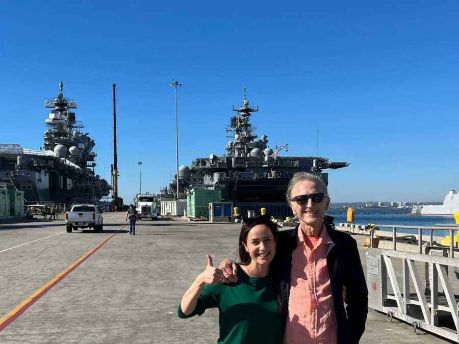 dad and daughter in front of a naval base