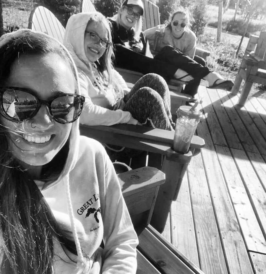 mother sits relaxing with three friends on a girls day away from kids
