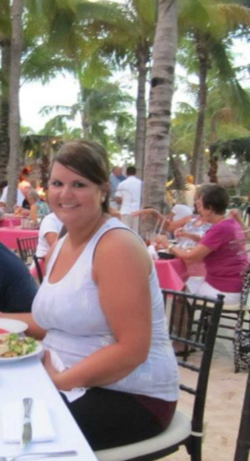 woman smiling by palm trees