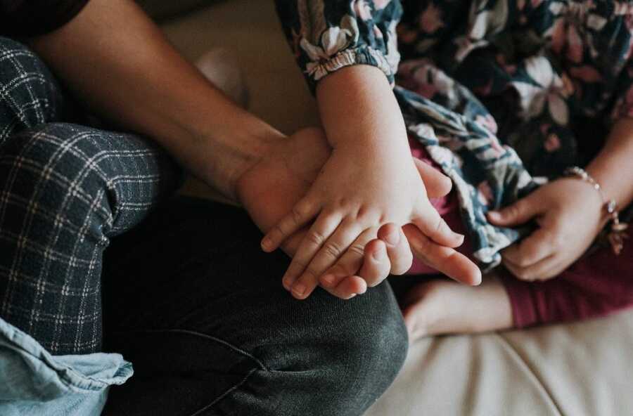 mom and daughter holding hands