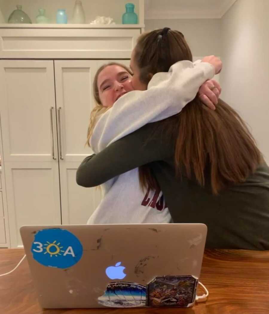 woman holding her daughter close before she leaves