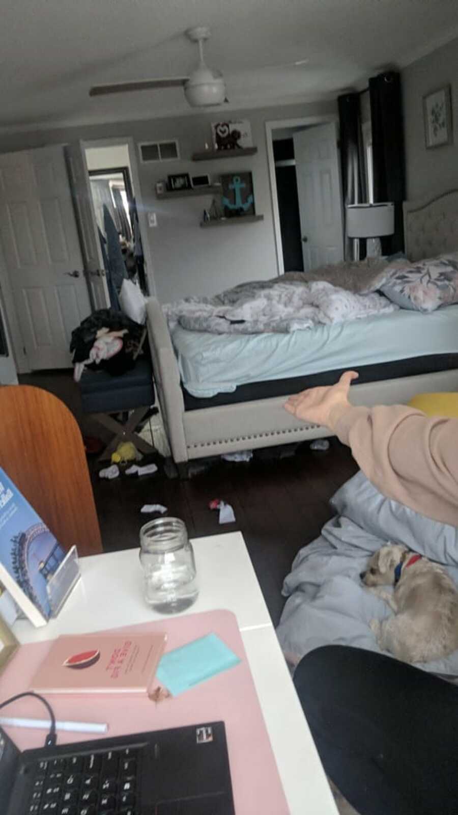 woman showcasing how messy her room is