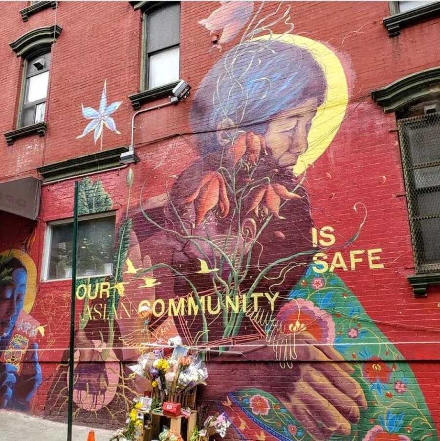 Mural of an elderly Asian woman in Chinatown with the words 'Our Asian community is safe'