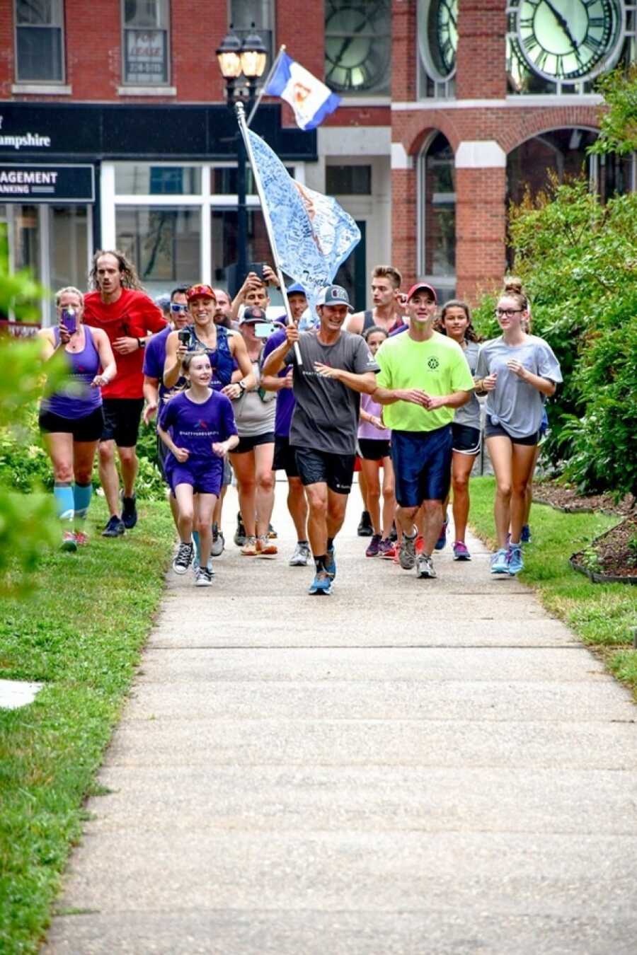 man running as girlfriend looks on