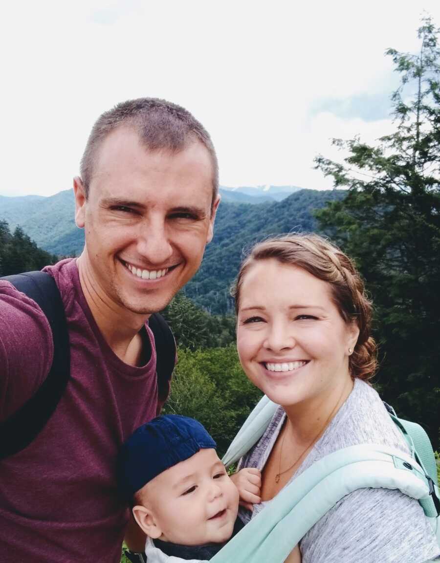 mom and dad taking a picture on a trail 