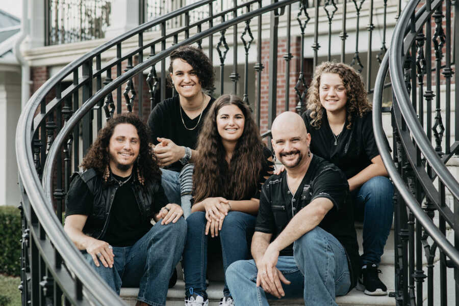 family posing all together on steps