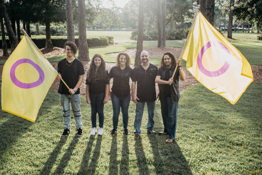 family waving intersex flags in union