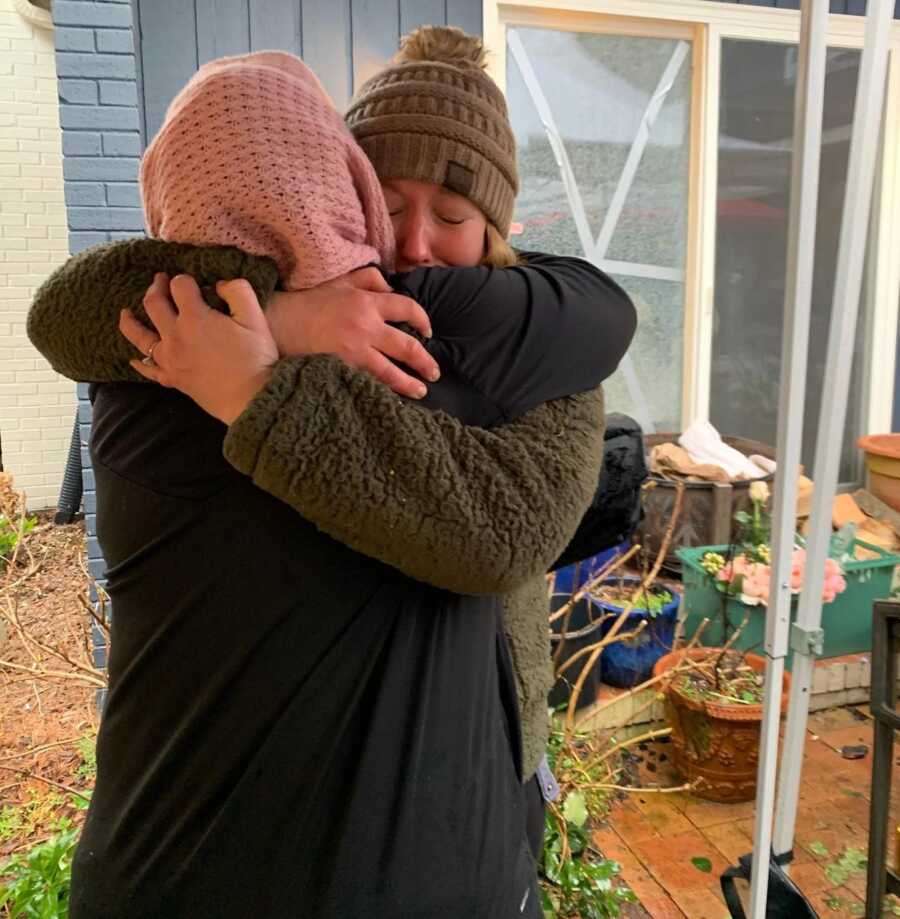 woman hugging another widow 