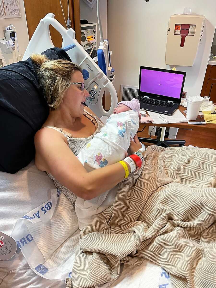 surrogate mother holds baby for the first time