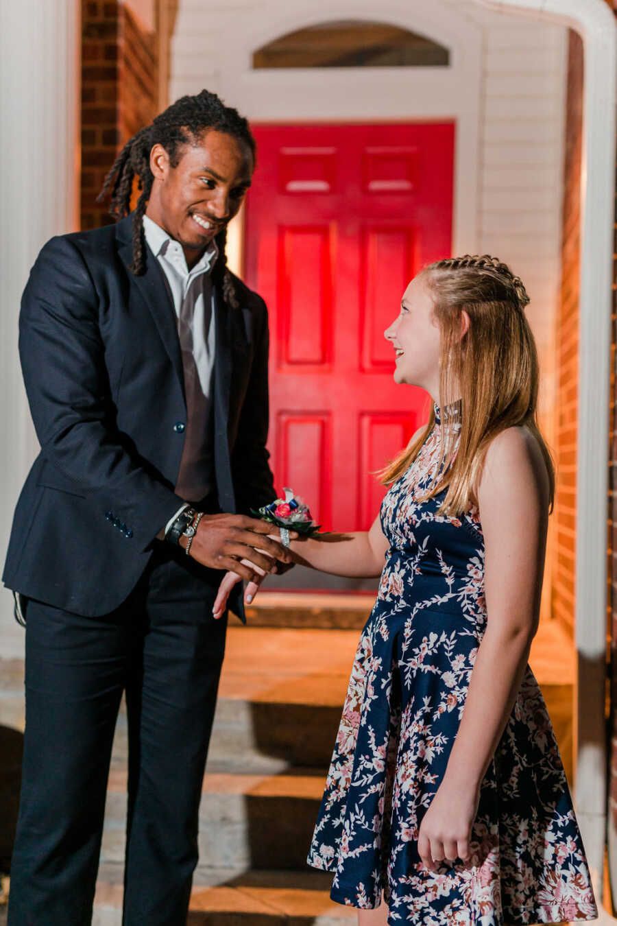 girl getting her flowers placed on her wrist