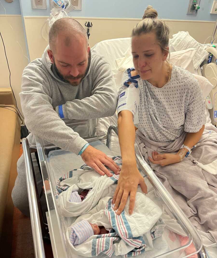 woman and husband watching over their newborns