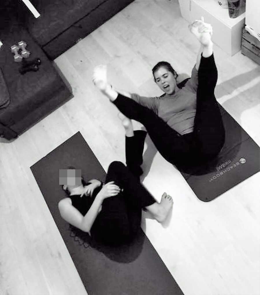 stepmom and stepdaughter exercising on yoga mat 