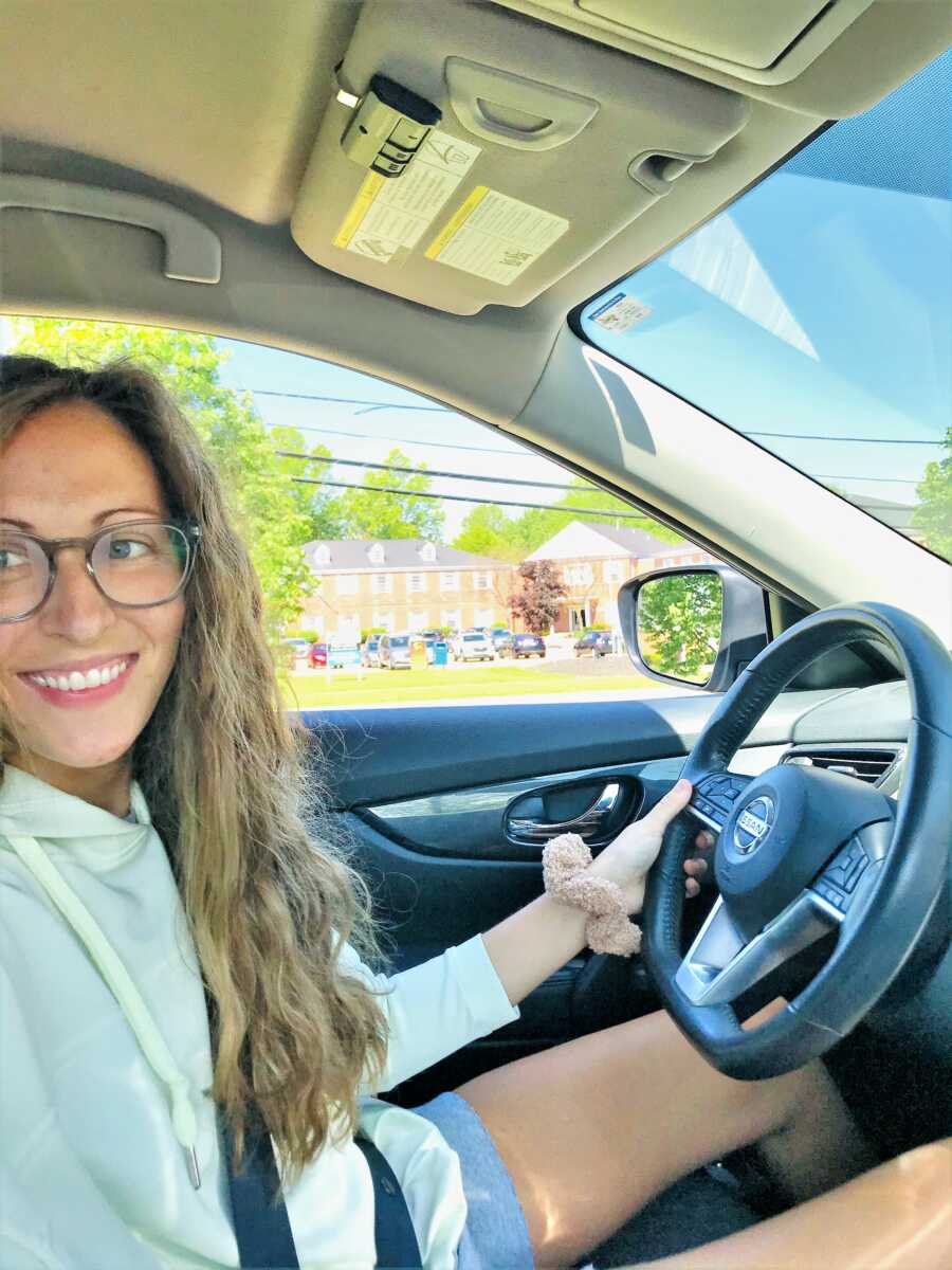 young woman battling chronic migraines driving a car