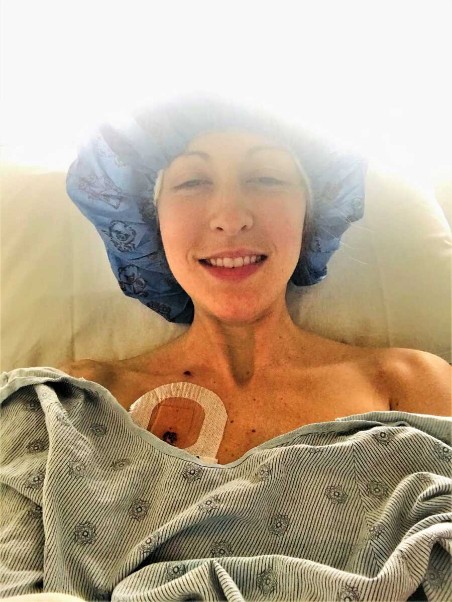 young woman battling chronic migraine laying on a hospital bed