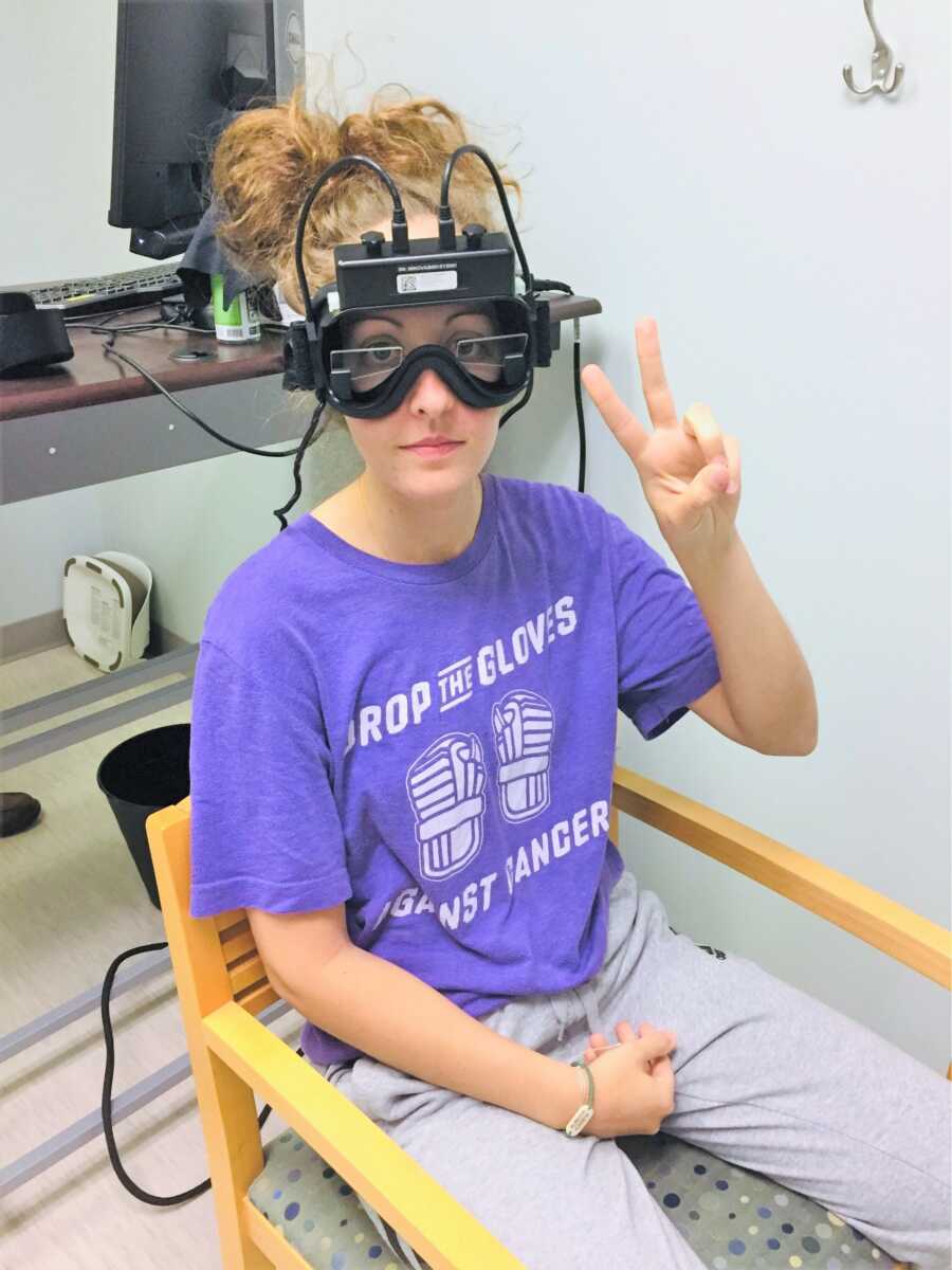 Young woman suffering from chronic migraine going through test to treat her illness