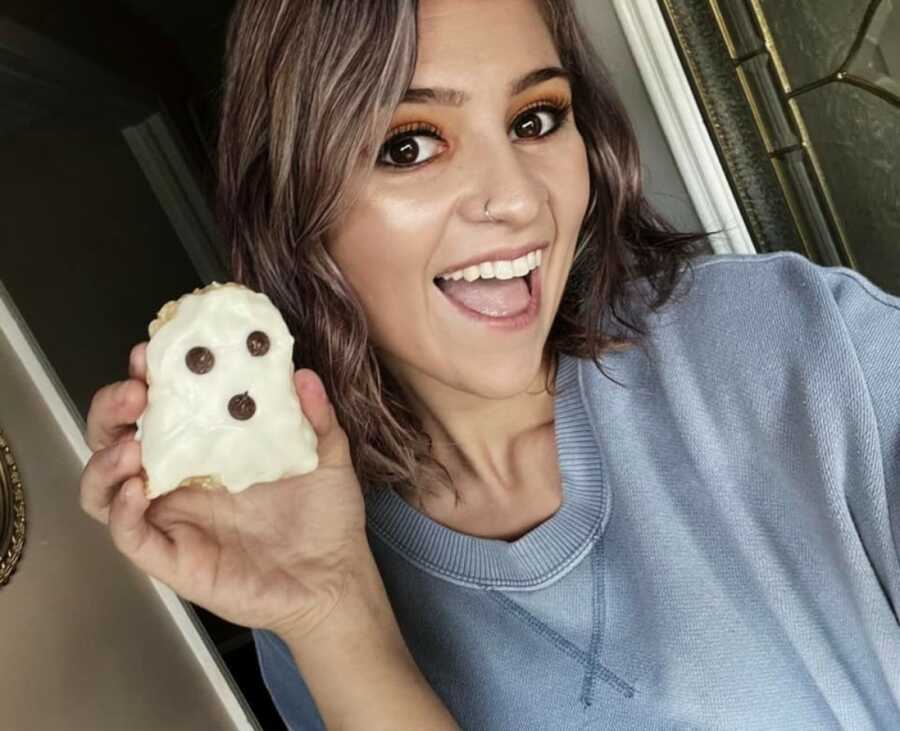 woman eating a cookie she made