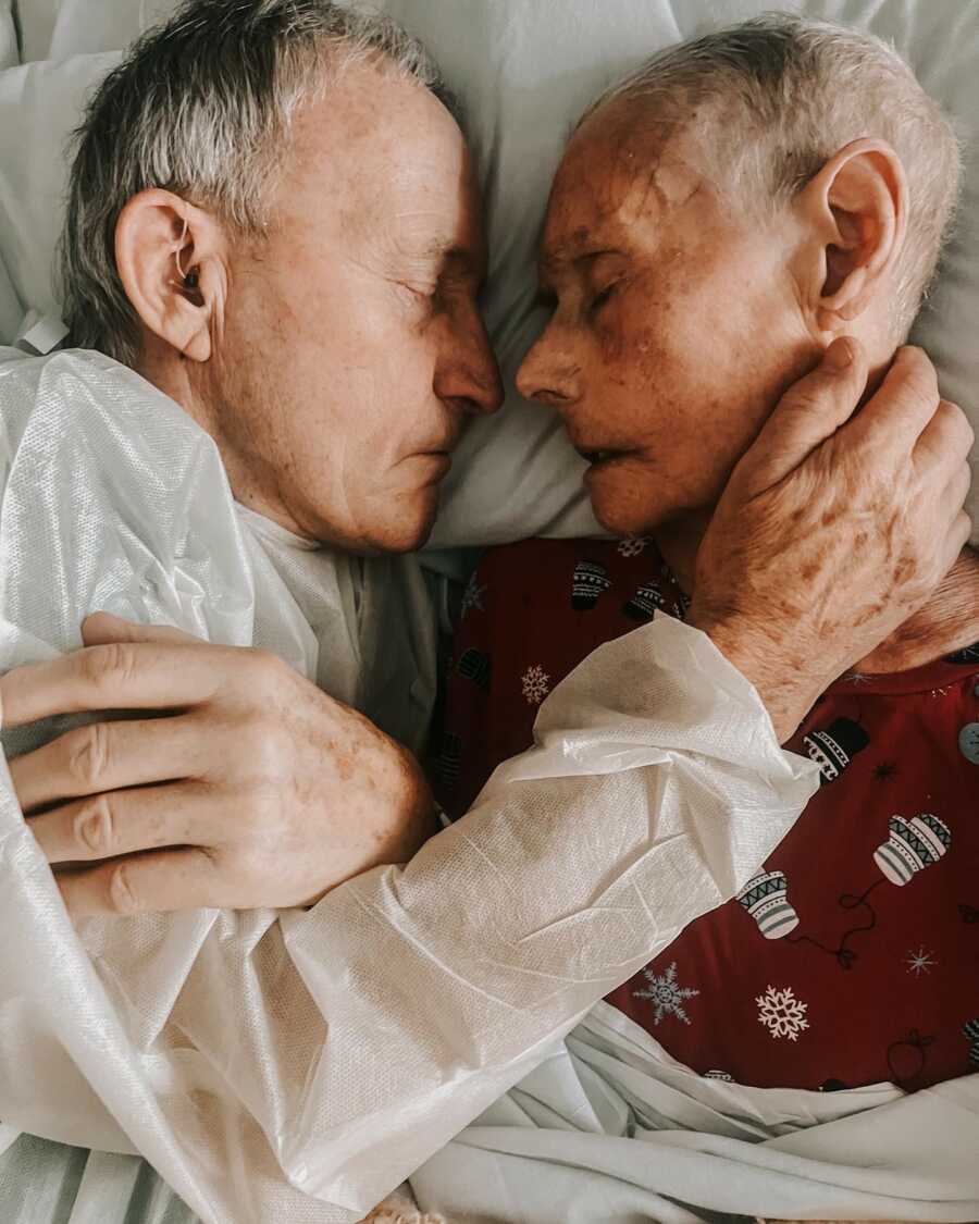 man holding his wife close before she passes