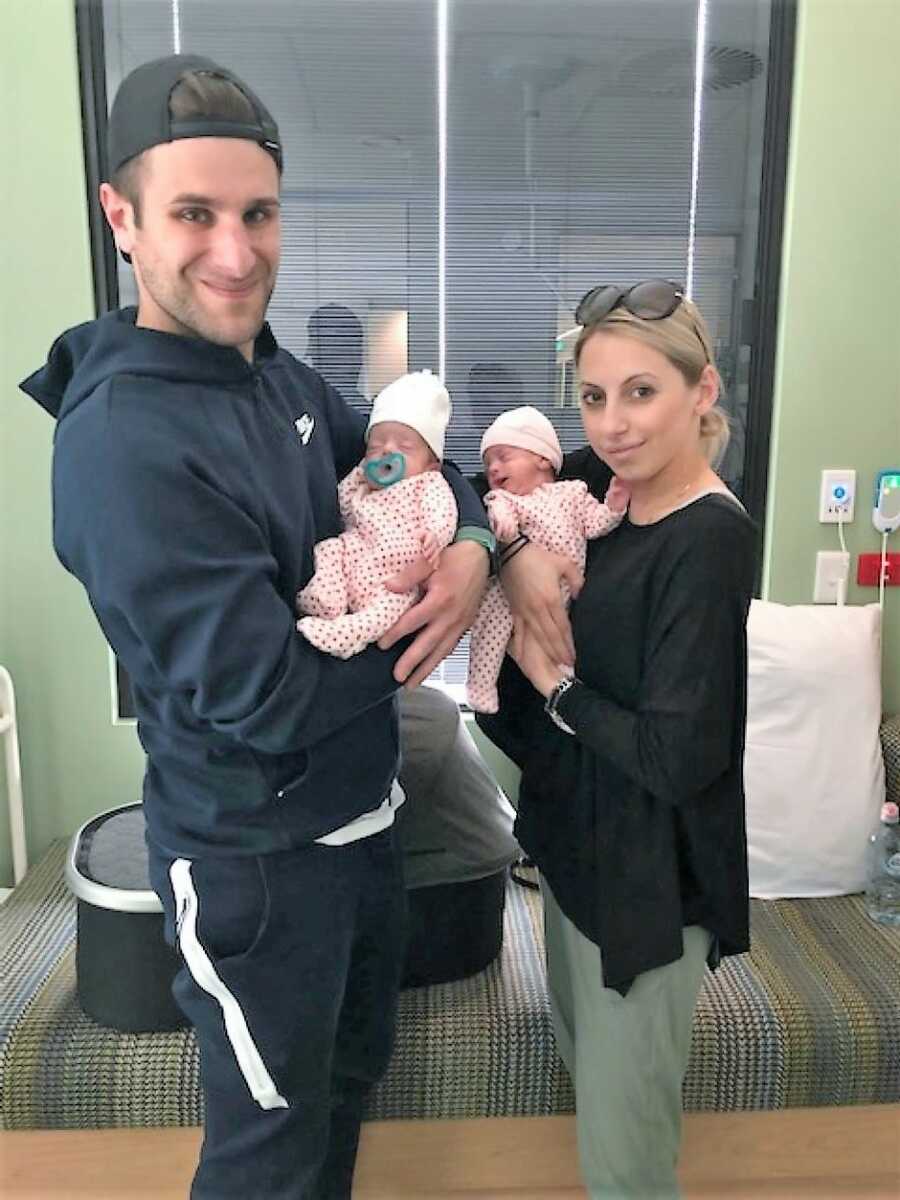 Mom and dad hold preemie twins at NICU 