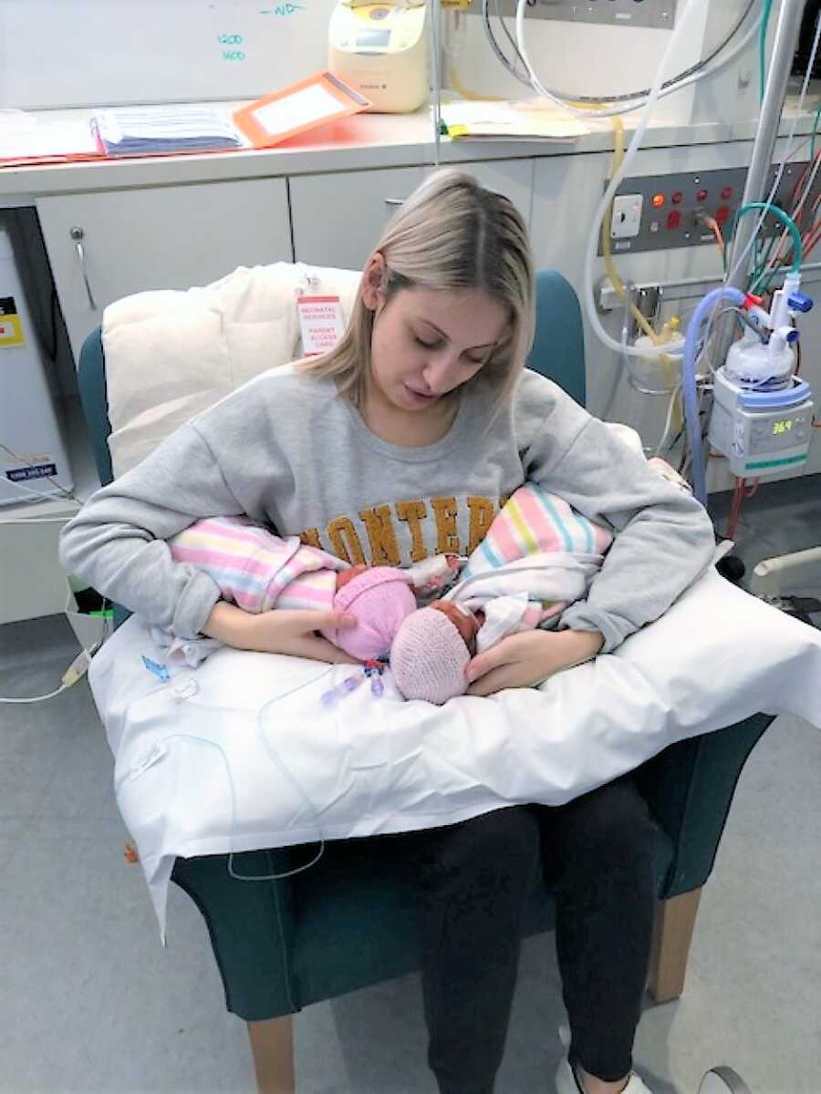 Mom holding TTTS preemies on a pillow at NICU 