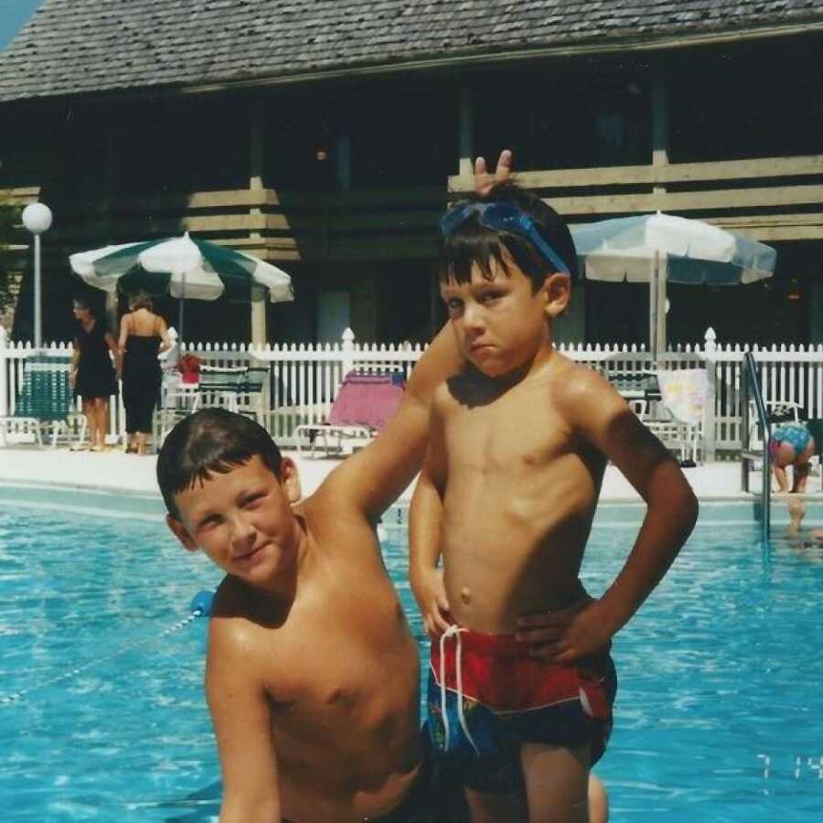 brothers in the pool playing together