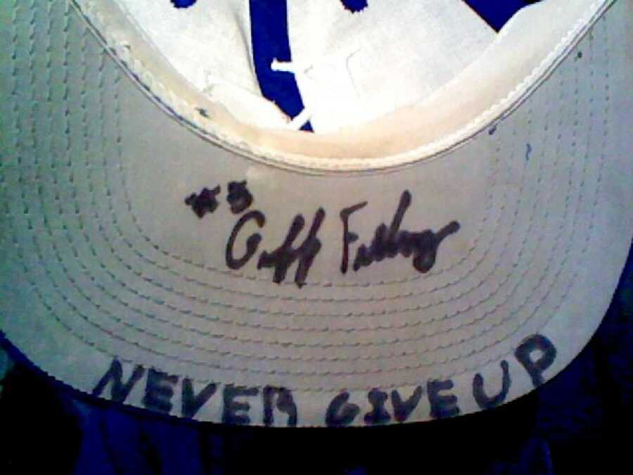 boy who wrote never give up in his baseball cap