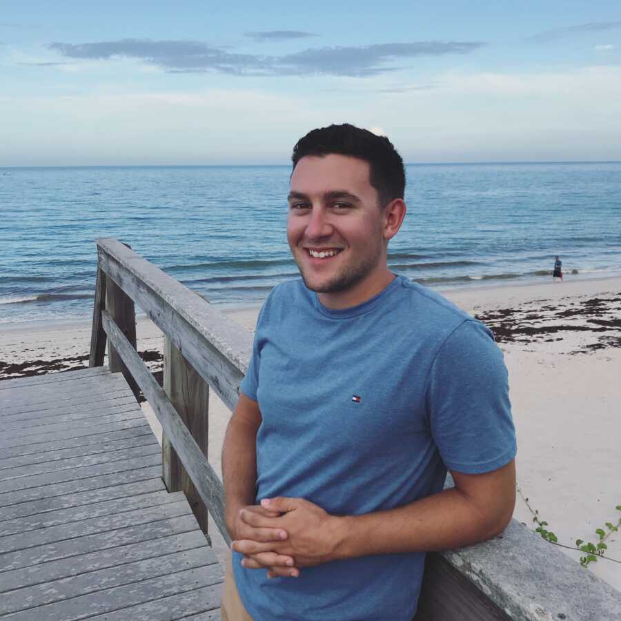teen boy posing by the ocean
