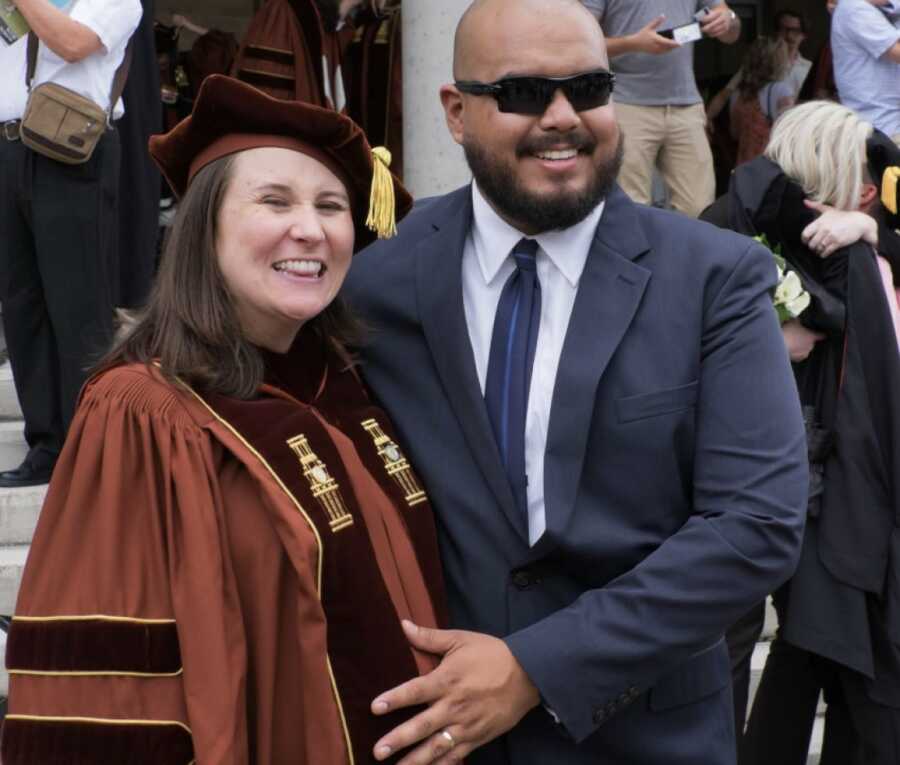 woman graduating with her husband by her side