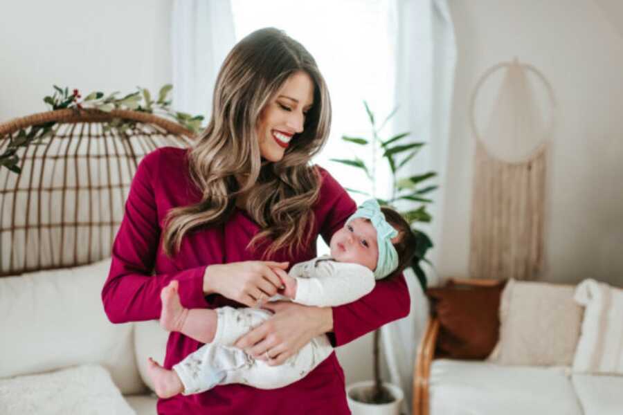 woman holding her child and smiling down at them