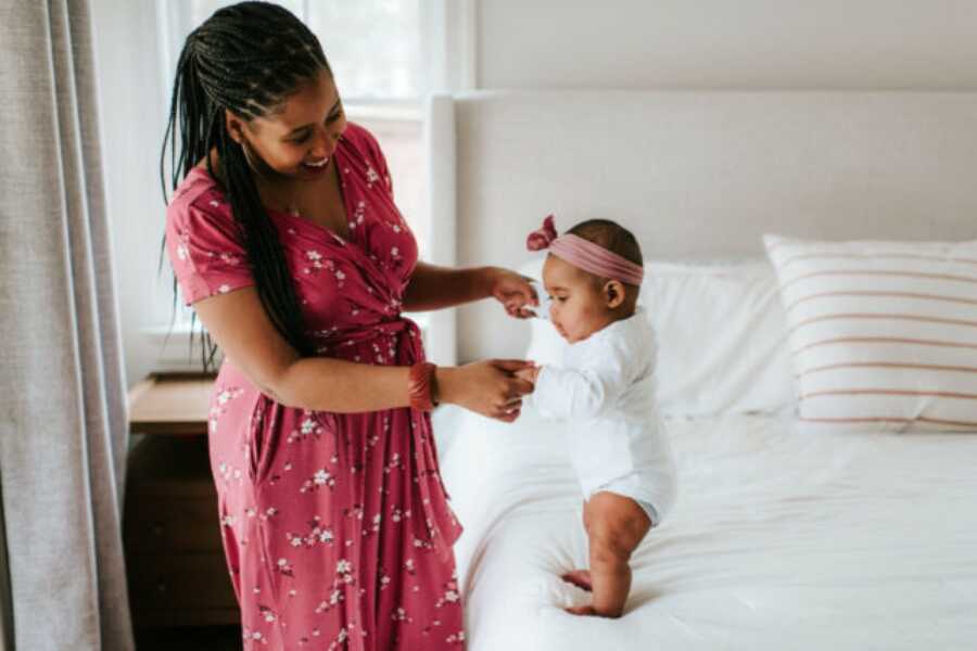 mom and daughter playing on the bed