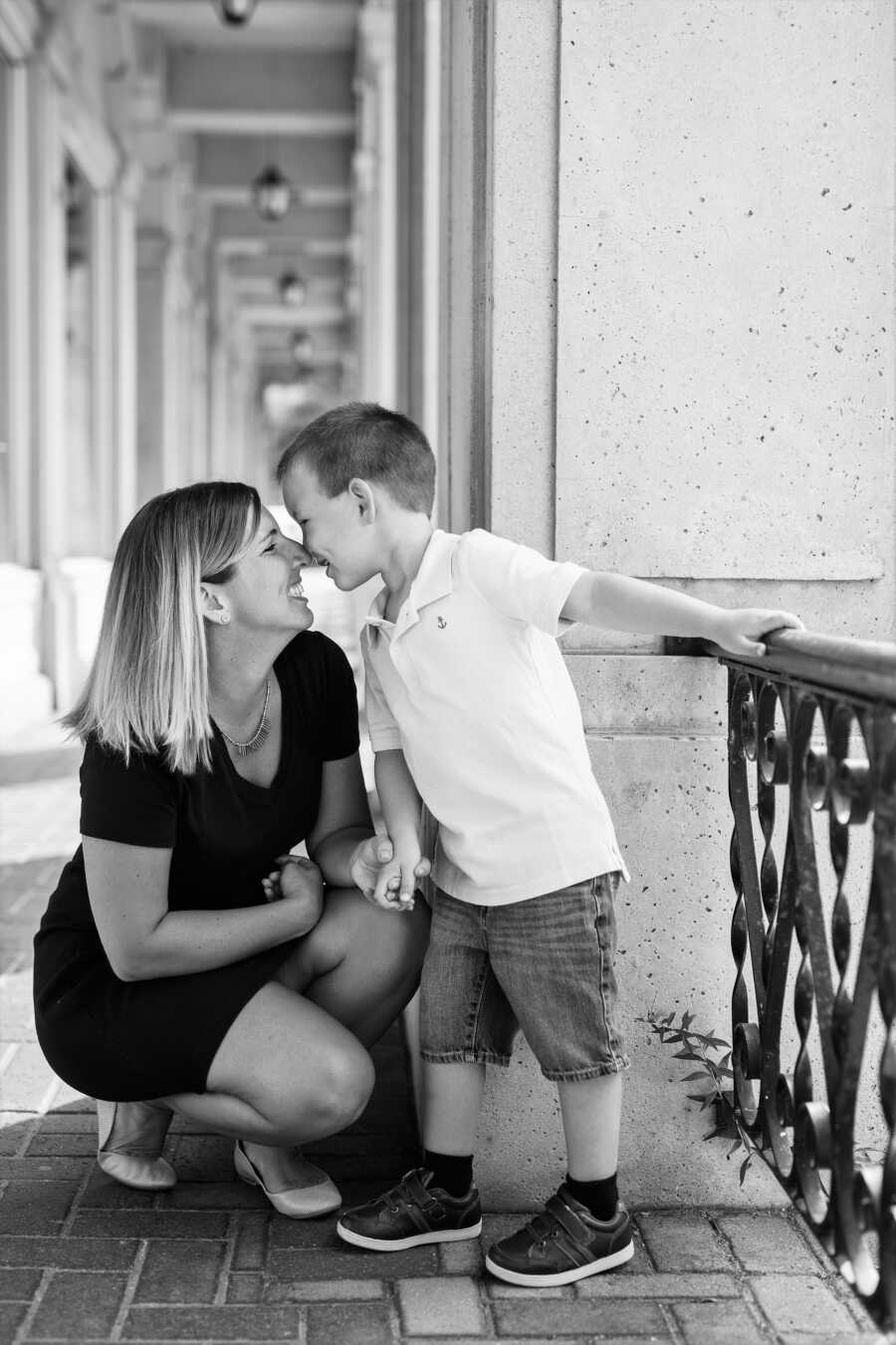 mom diagnosed with OCD sitting down while her son gives her an Eskimo kiss