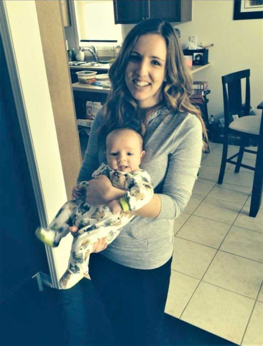 OCD postpartum mom holding baby boy at home 