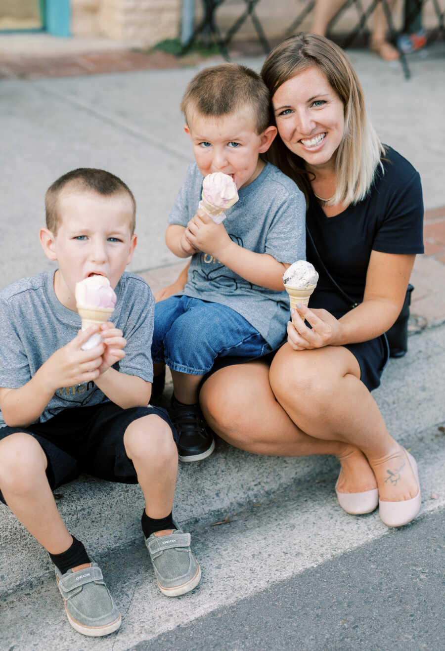 Mom diagnosed with OCD eats ice cream cones with her two sons sitting on stairs 