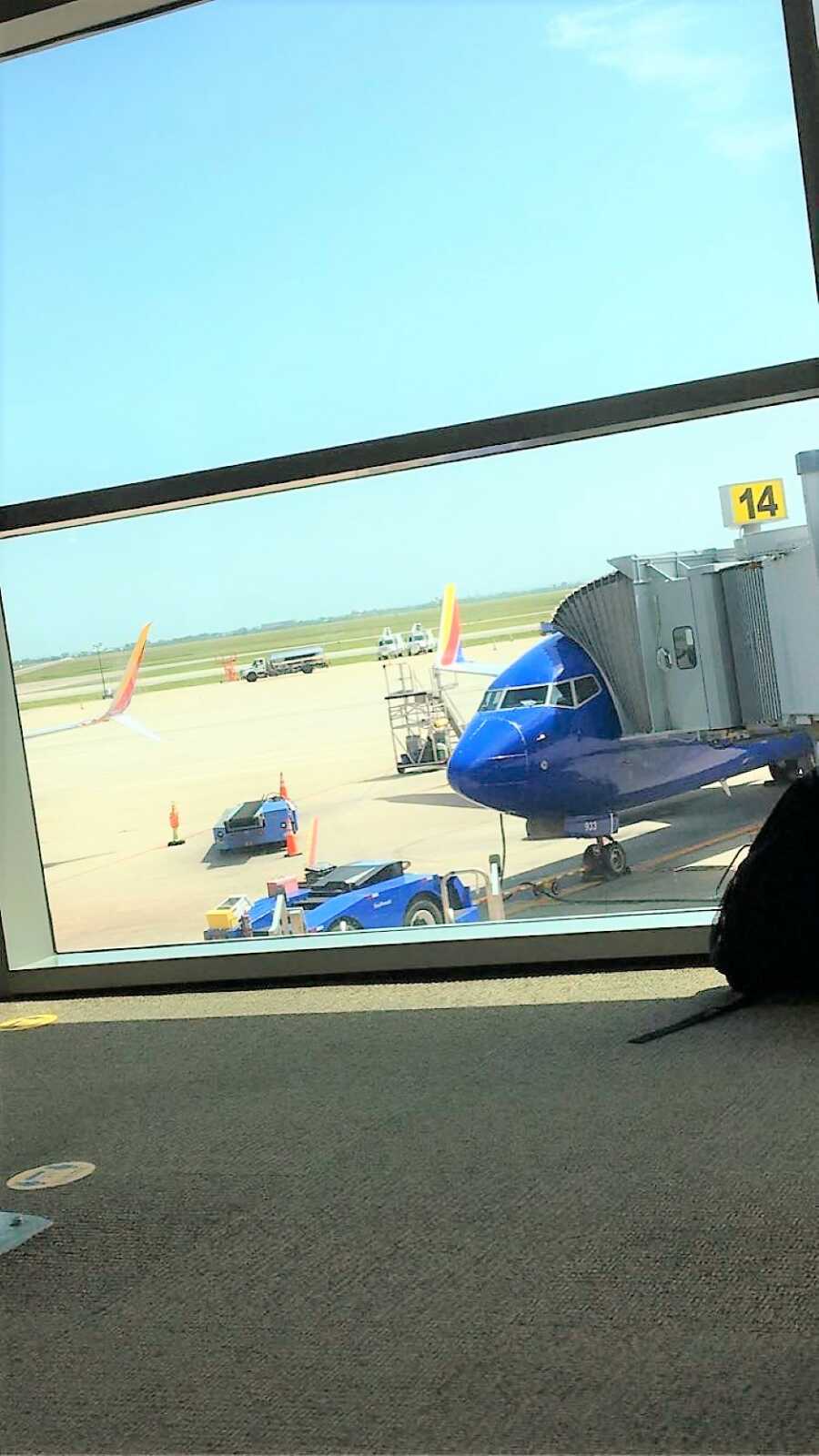 View from the inside of the airport of a Southwest Airline plane boarding 